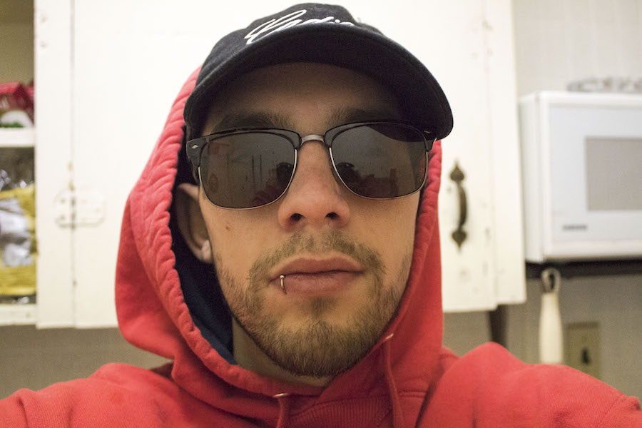 Picture of a Me wearing sunglasses and a red hoodie.